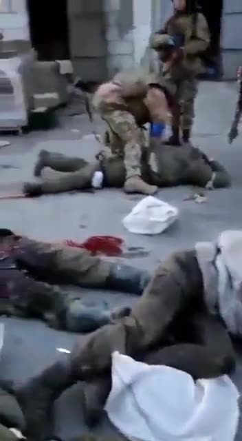 Additional angle of Ukrainian soldiers torturing Russian prisoners.