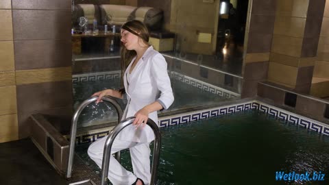 White Outfit Enjoys a Relaxing Wetlook Pool Moment