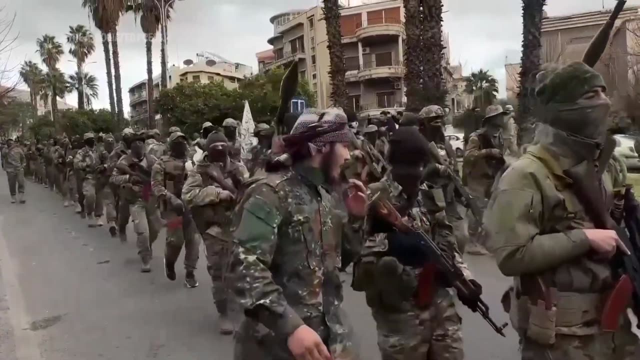 Hundreds of Syrian armed rebels parade in Damascus as a show of force