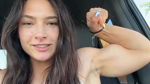 Beautiful muscle girl flexing