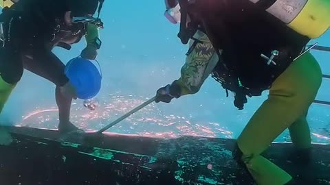 Divers Clean Boat Upside-Down