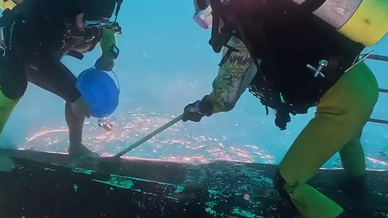Divers Clean Boat Upside-Down