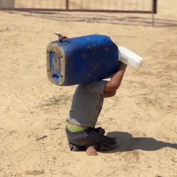 A disabled child in Gaza crawls on the ground, struggling to carry a water container