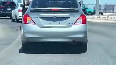 A kidnapped woman signaling for help on the highway