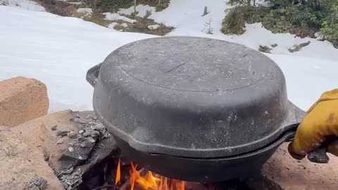 Cooking in a forest snow camp