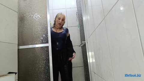 Wetlook girl in shower fully dressed in a sweatshirt