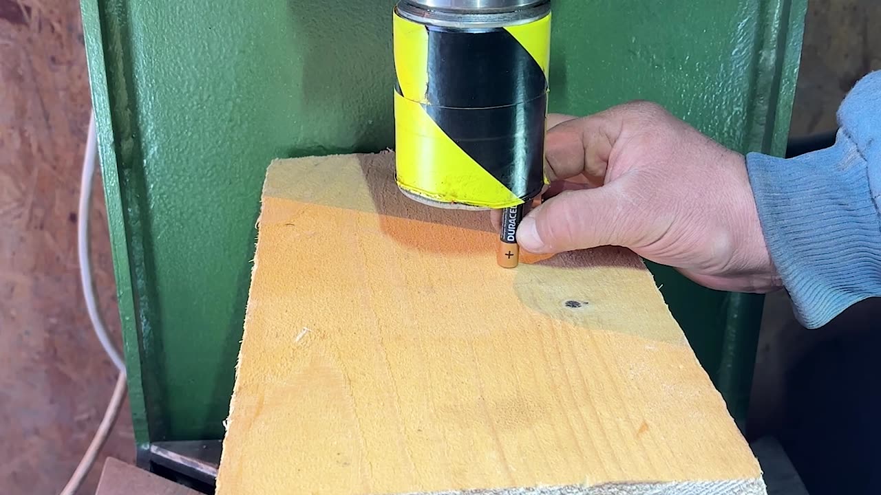 Hydraulic Press Crushing Battery In Wood