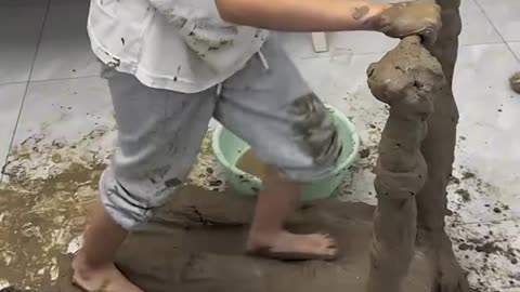 Kid building a treadmill from mud.hd