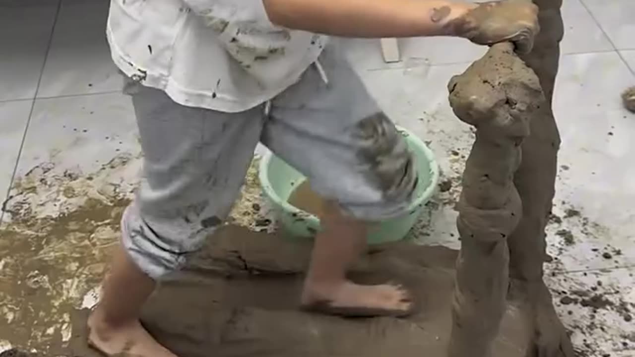 Kid building a treadmill from mud.hd