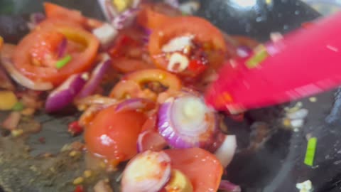 Stir fry spiced pepper and tomato.