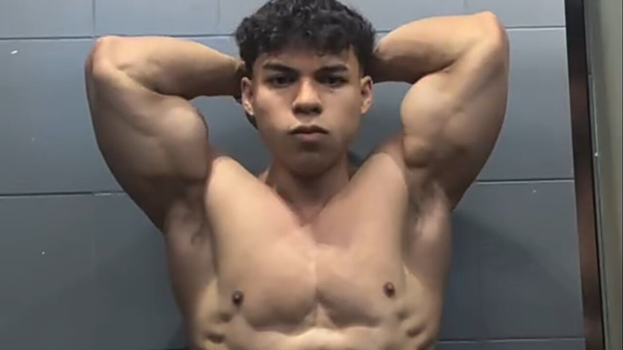 20 years old bodybuilder flexing muscles
