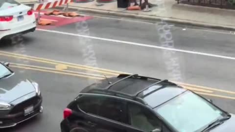 Just another lovely day in downtown Chicago with some thug trying to hit people on the street.