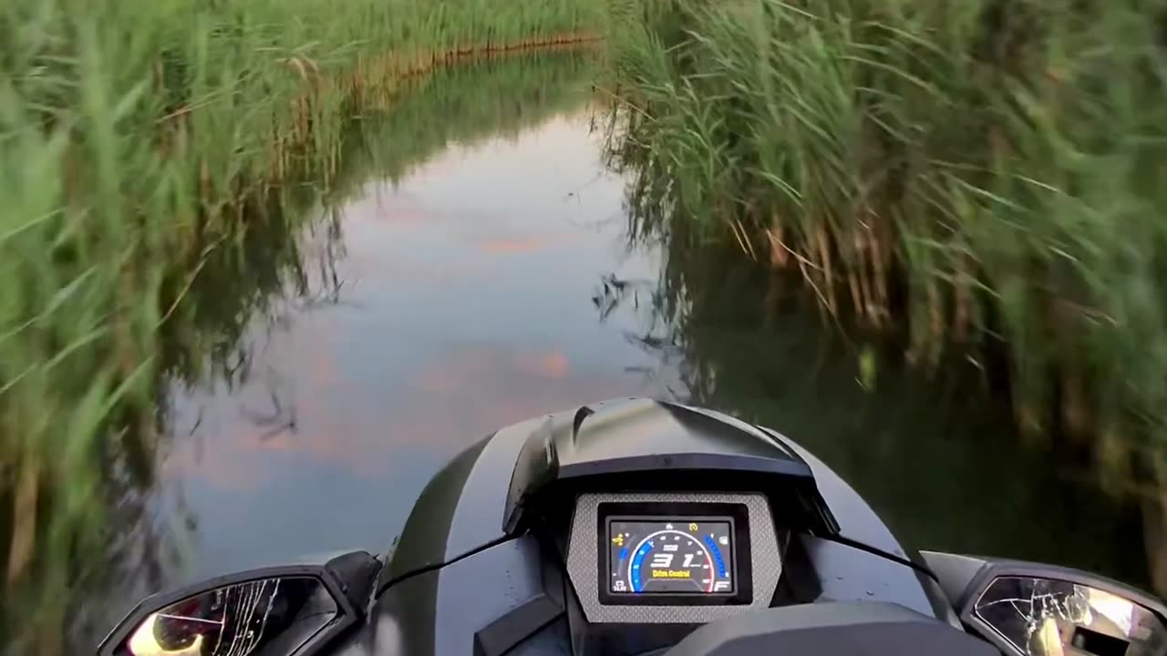 Jet Skiing Through a Marsh at Sunset