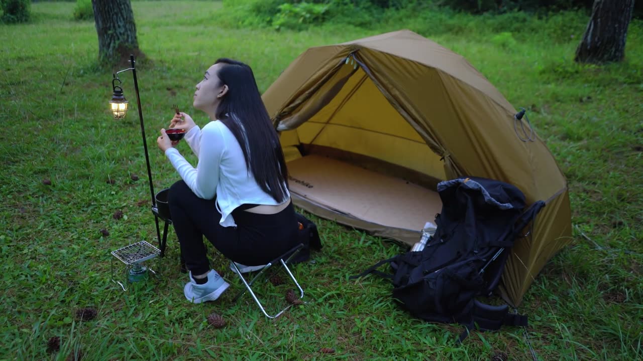 Camping deep in the forest, relaxing with stunning mountain scenery on a sunny day