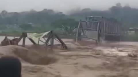 The moment the Natam Bridge was swept away by floodwaters in Simpang Empat Tanjung Village