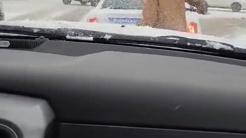 Man Clears Off Back Window Of Canadian Police Cruiser