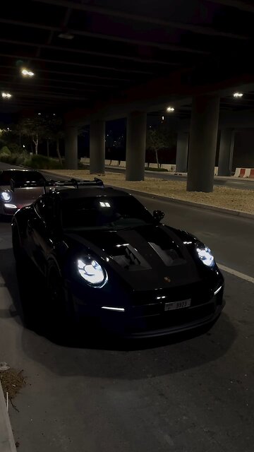 Sleek Black Porsche in Action: Power & Luxury Unleashed 🏎️🖤