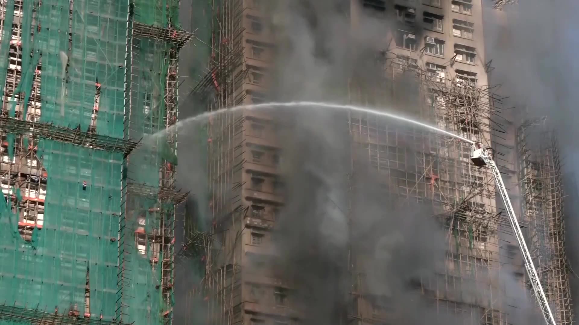 People reportedly trapped as fire engulfs Hong Kong residential high-rise