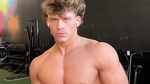 Handsome muscular guy showing off his muscles