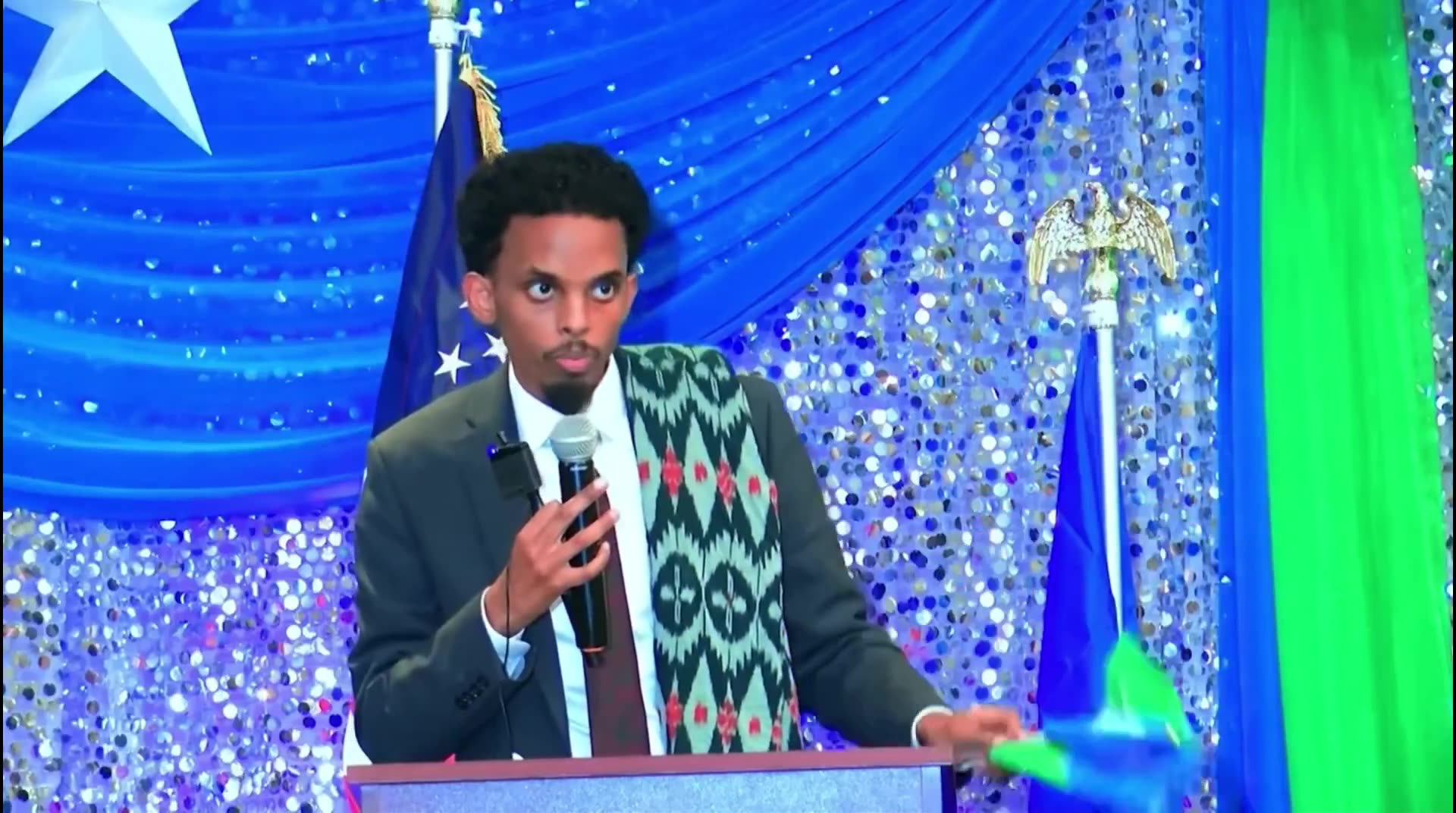 Omar Fateh waves foreign flag, speaks a foreign language