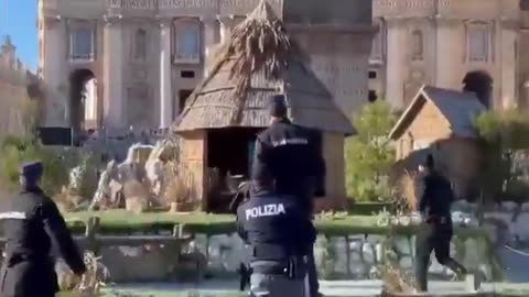 Police tackle a topless leftist protestor in the Vatican's St Peter's Square after