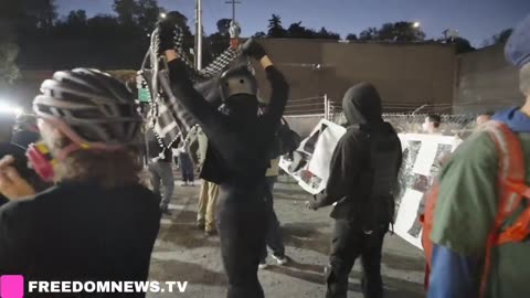 Anti-ICE protesters march with "Abolish ICE" banner outside ICE facility in Portland, Oregon. 