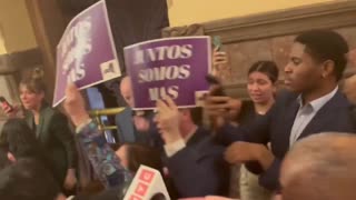 WATCH: TOM HOMAN eats an apple and smirks as protesters scream and chant at him.