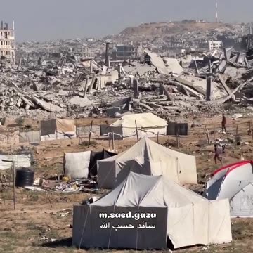 Temporary tents amidst the rubble of demolished buildings