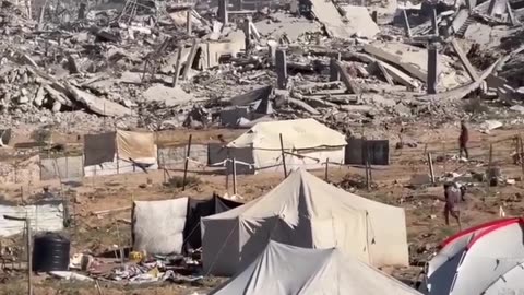 Temporary tents amidst the rubble of demolished buildings