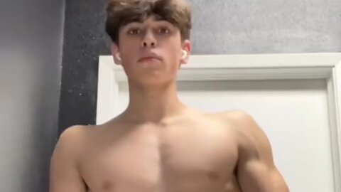 Teen boy flexing muscles