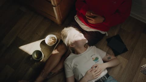 A Woman Resting On Her Boyfriend's Lap