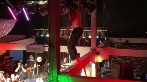 Bandmate Swings From Chandelier