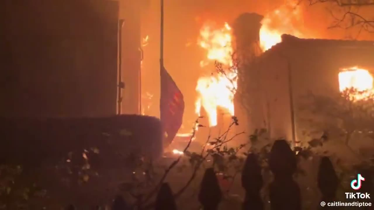 There’s NO WATER as this man has to watch his house burn — the flag flying at