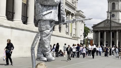 Child Offers Juice to Silverman Statue