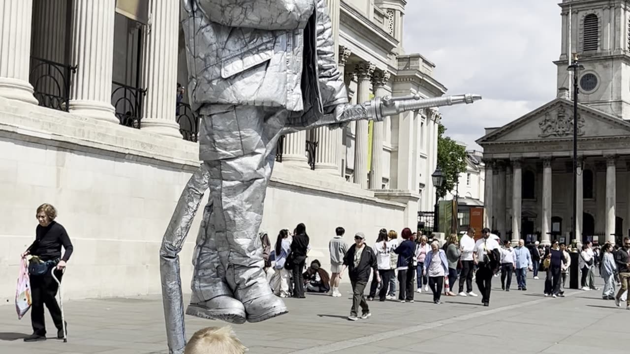 Child Offers Juice to Silverman Statue