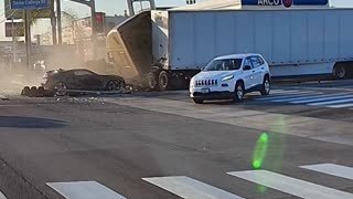 A semi truck plows into stopped traffic at a red light in Fullerton, California