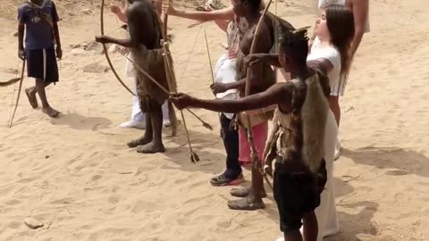 Hadzabe Tribe bushmen teaching visitors Arrow skills
