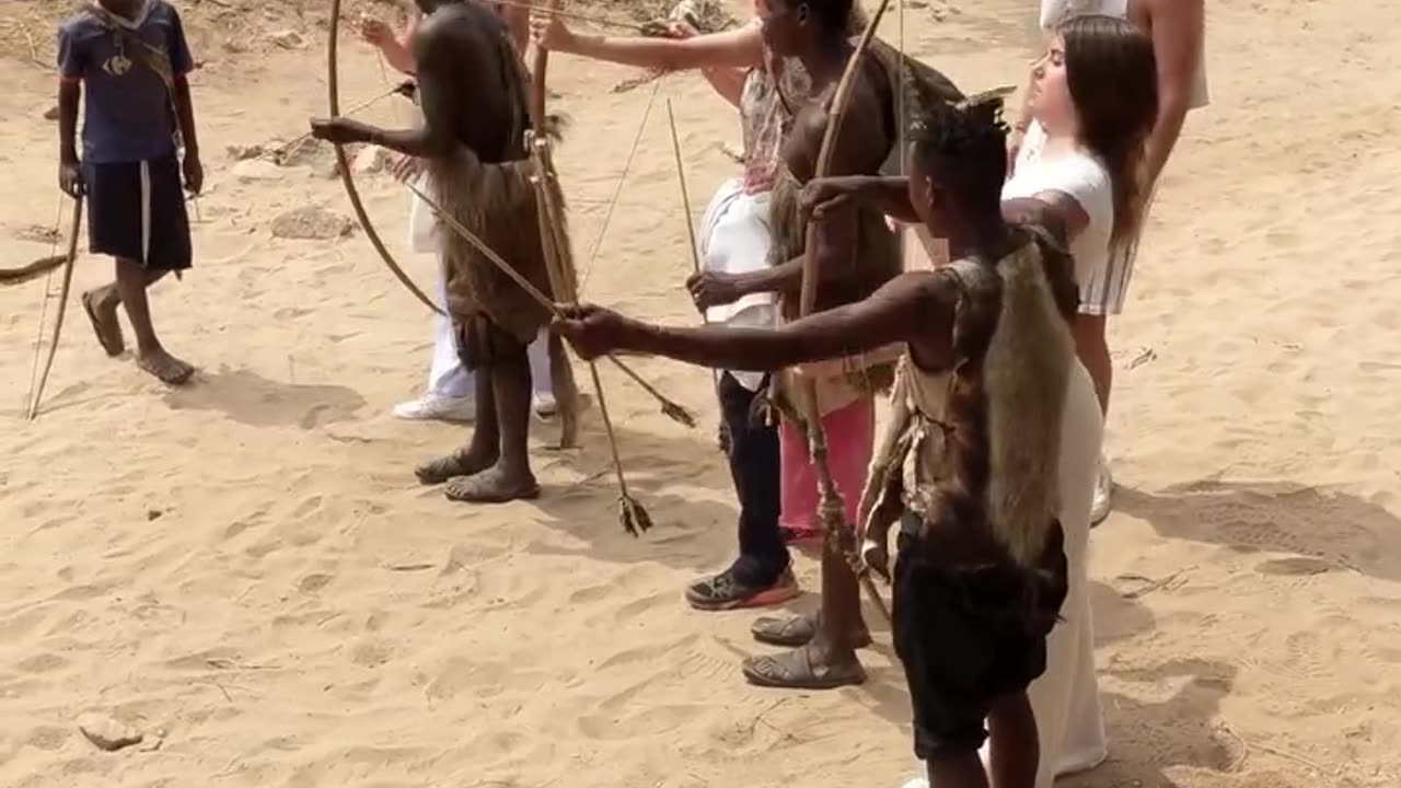 Hadzabe Tribe bushmen teaching visitors Arrow skills