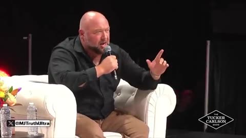 Alex Jones on stage in front of a massive crowd talking about sending the globalists to prison