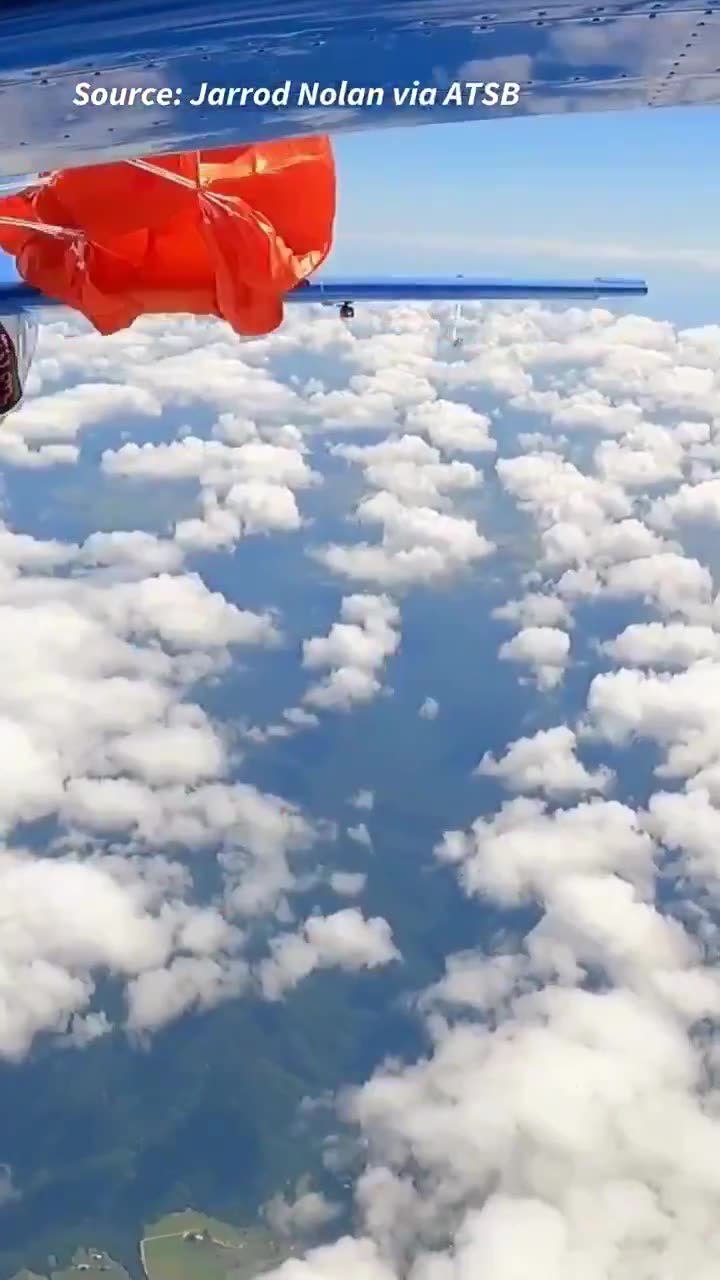 Wild footage shows a skydiver’s parachute snagged on a plane’s tail at 15,000ft during
