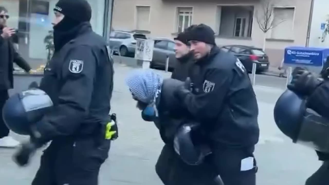 German police officers detained a protester in Berlin