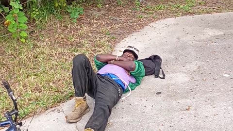 Passerby Checks On Friend Laying By Roadside