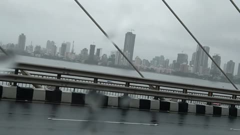 Driving in Mumbai, India on The Bandra–Worli Sea Link Bridge, Rainy Day, Skyline From a Distance