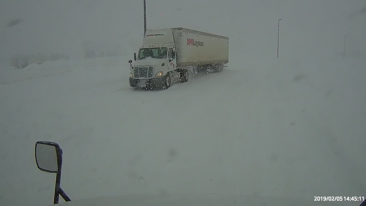 Truck driver picking up and delivering freight in a snow storm