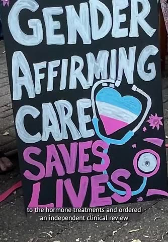 A man in a dress says he is outraged with Queensland for banning puberty blockers for CHILDREN