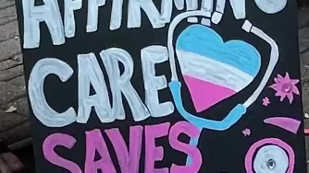 A man in a dress says he is outraged with Queensland for banning puberty blockers for CHILDREN