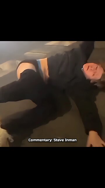 A man gets gently escorted to the side by a car.