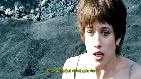 A woman is bathing in the wilderness, unaware that a man behind her is suddenly undressing