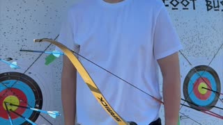 🏹 As the sun sets, a young archer draws back his recurve bow