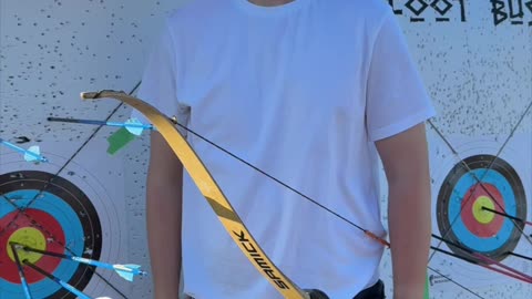 🏹 As the sun sets, a young archer draws back his recurve bow